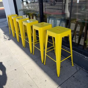 Six Stackable Yellow Metal Bar/Counter Stools
