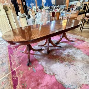 Regency-Style Triple-Pedestal Mahogany Dining Table with Two Leaves.”